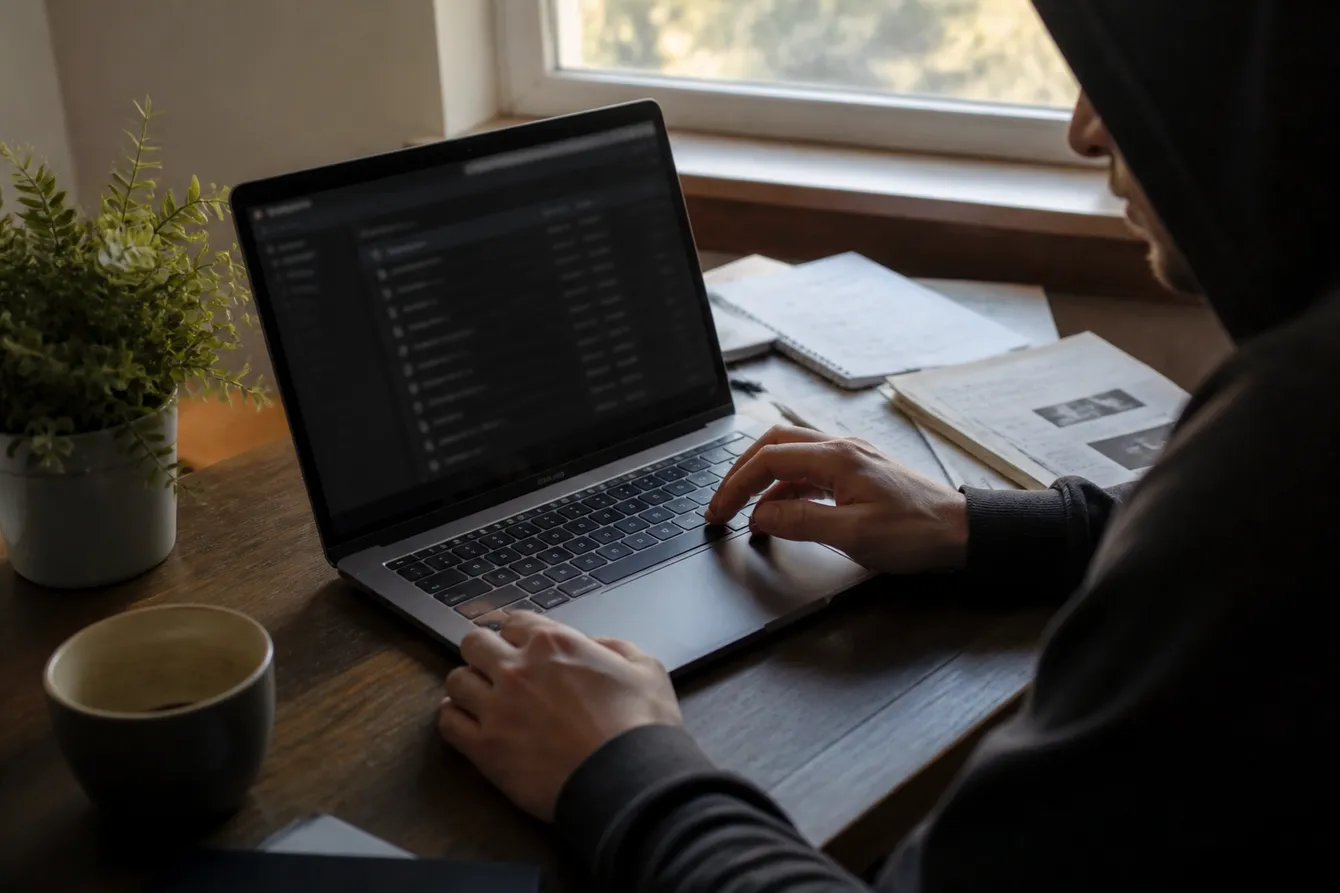 A person carefully navigating a Tor market link on a laptop, surrounded by security tips and a cozy environment